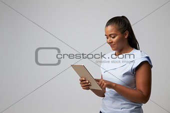Studio Portrait Of Businesswoman Using Digital Tablet