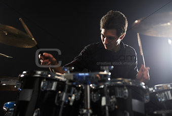 Young Drummer Playing Drum Kit In Studio