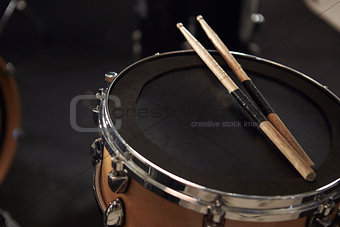 Close Up Of Sticks Resting On Snare Drum