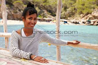 Middle aged African American woman by the sea, vertical