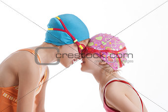 Two girls in swimming suits look at each other