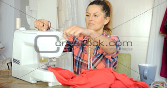 Female using sewing machine
