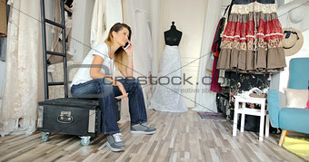 Woman in parlour talking by phone