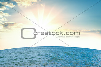 Sea against background of sunrise with clouds