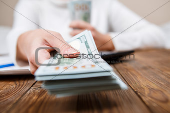 Hands of person proposing money to you - closeup shot