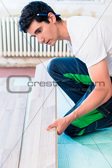 Handyman flooring in home construction site