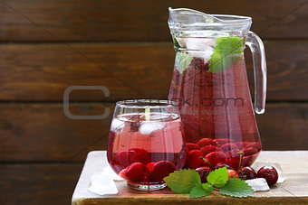 Organic cherry lemonade with fresh berries on the table