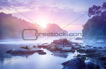 Landscape with sunrise and mist over river