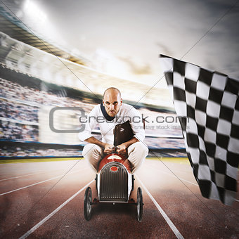 Successful businessman in a small car on the finishing line