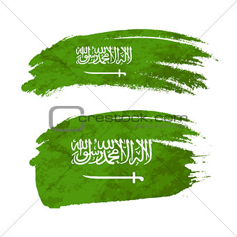 Grunge brush stroke with Saudi Arabia national flag on white
