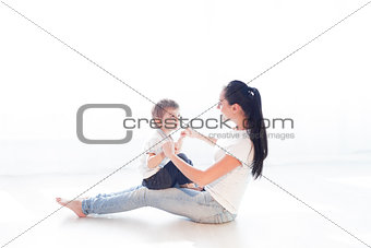 mom plays with her son on the floor of the happiness