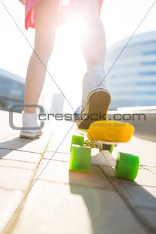Girl with penny skateboard shortboard.