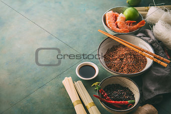 Different types of rice and dried asian noodles and spices.