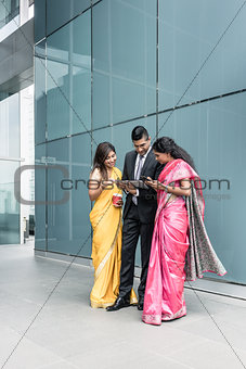Indian business people using high-tech devices during break