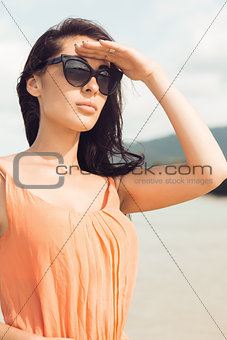 Pretty girl in sunglasses on the beach.