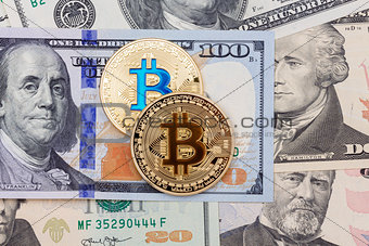 Bitcoins on money bills background.