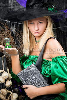 vertical portrait of a beautiful witch with a magic book in his 