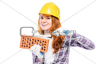 woman builder with a brick in a yellow hard hat against a white 
