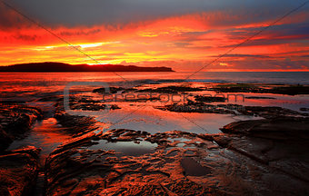 Red sunrise blankets Pearl Beach Australia