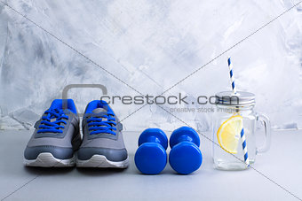Sport composition with sports equipment and mason jar with lemon