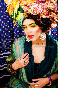 beauty bright woman with creative make up, many shawls on head l