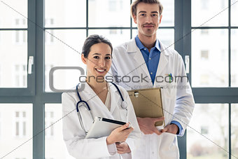 Portrait of two determined physicians looking at camera in a mod