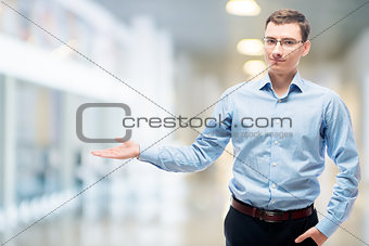 Businessman presenting space to the left in office