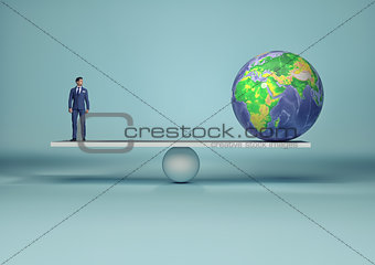 Businessman in balance with earth globe