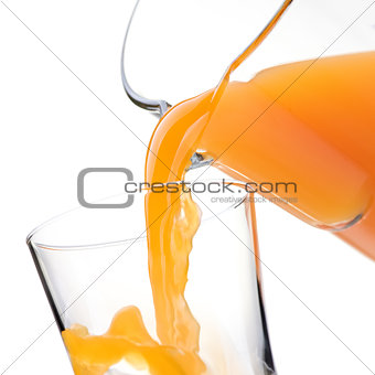Pouring refreshing orange juice into a glass