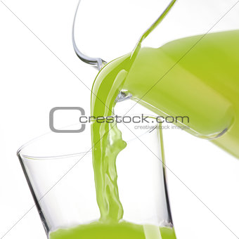 Pouring detox green juice in a glass