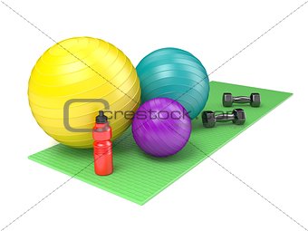 Fitness ball, dumbbells and plastic water bottle on green yoga m