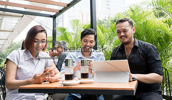 Three friends using devices connected to the wireless internet n