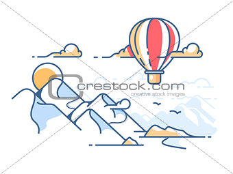 Balloon flying in sky above mountains