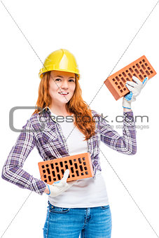 strong woman builder in yellow breeze with bricks on white backg