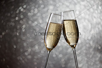 Picture of two wine glasses with champagne on gray background