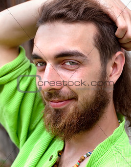 Portrait of a Teenage Boy with Long Hair and Beard.