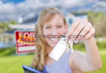 Woman Holding New House Keys with Blank Card In Front of Sold Re