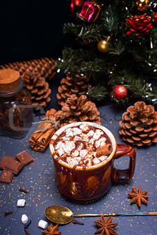 hot chocolate with marshmallow slices in a brown ceramic mug 