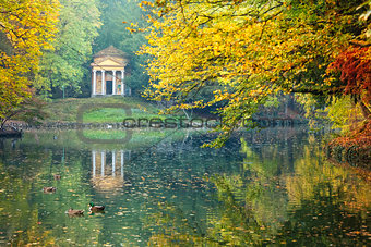 Reflection of a little temple in a pond of the Park of Monza sur