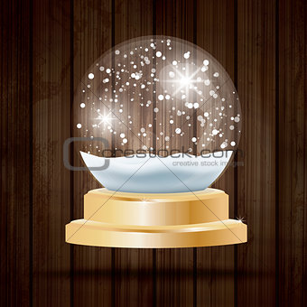 Christmas Crystal Ball with Snow on Wooden Background.