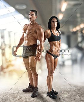 Muscled man and woman at the gym
