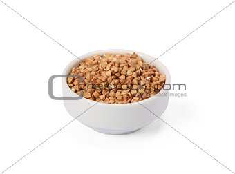 Buckwheat groats in whitebowl isolated on white background