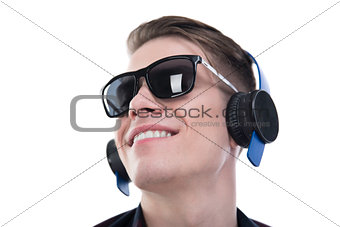 Enjoy the music! Handsome young man in sunglasses and headphones.