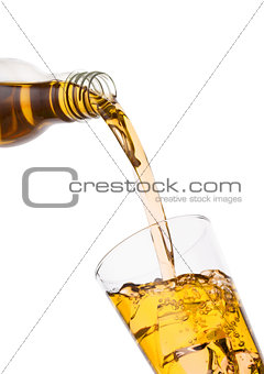 Pouring fresh apple juice from bottle to glass 