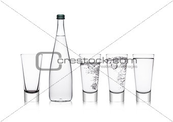 Bottle and glasses with healthy still clear water