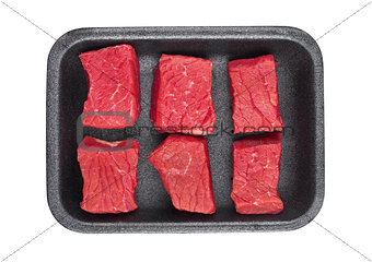 Pieces of fresh raw beef meat in plastic tray