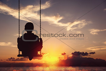 Freedom and carefree of a young female on a swing