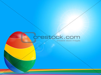 Striped Easter egg on rainbow over blue sky