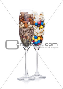 Popcorn and candies glass with healthy nuts glass