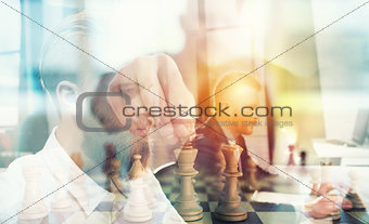 Business tactic with chess game and businessmen that work together in office. Concept of teamwork, partnership and strategy. double exposure